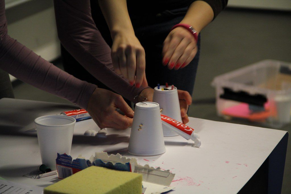 Hands assembling workshop materials on a table